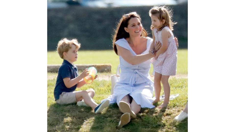 Kate cuddling Charlotte and sitting next to George at polo match, 2018