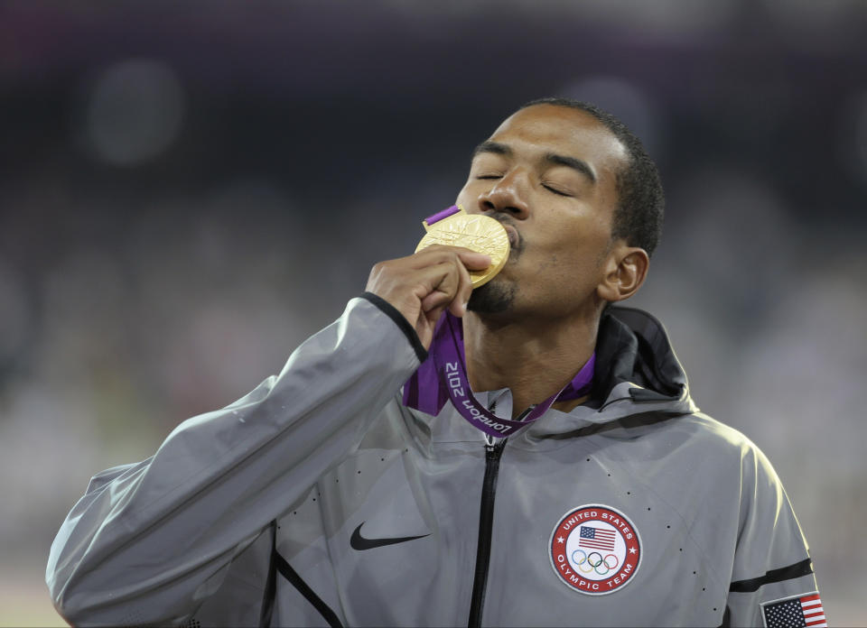 FILE - United States' Christian Taylor kissing his gold medal during the ceremony for the men's triple jump at the Olympic Stadium during the 2012 Summer Olympics in London, Aug. 9, 2012. On Friday, Taylor will start his bid to make a third Olympic team. It’s been quite a ride for the 34-year-old whose career also includes four world championship titles and coming within eight centimeters of setting a world record. (AP Photo/Matt Slocum, File)