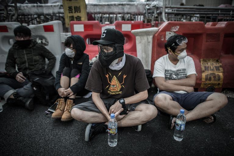 Pro-democracy demonstrators guard a barricade at a protest site in Hong Kong, on October 13, 2014