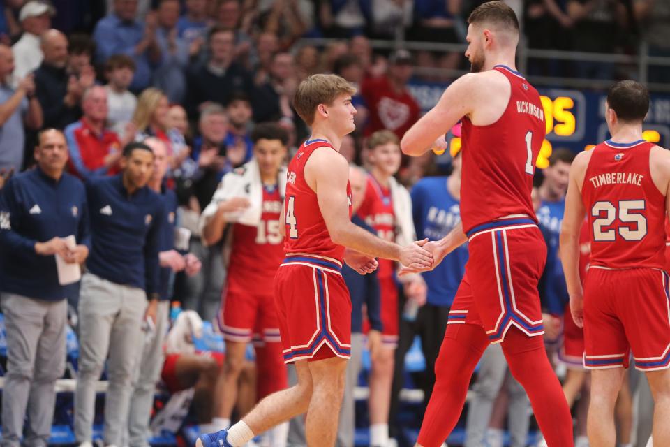Kansas junior guard Patrick Cassidy (14) slaps hands with senior center Hunter Dickinson as he enters the court in the last minute in the second half of the Sunflower Showdown inside Allen Fieldhouse Tuesday, March 5, 2024.