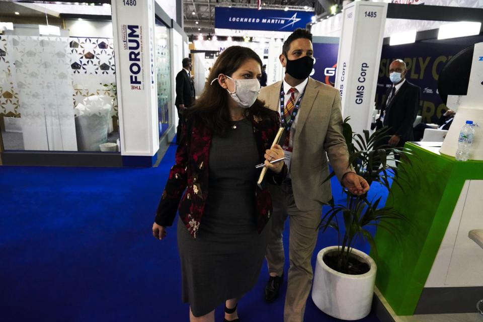 Mira Resnick, a U.S. deputy assistant secretary of state for regional security in the bureau of political-military affairs, walks with Jay Treloar, a press attache at the U.S. Embassy in Abu Dhabi, at the Dubai Air Show in Dubai, United Arab Emirates, Tuesday, Nov. 16, 2021. The U.S. remains "fully committed" to a proposed sale of advanced F-35 stealth fighter jets to the United Arab Emirates despite the Biden administration slowing down the deal, Resnick told The Associated Press on Tuesday. (AP Photo/Jon Gambrell)