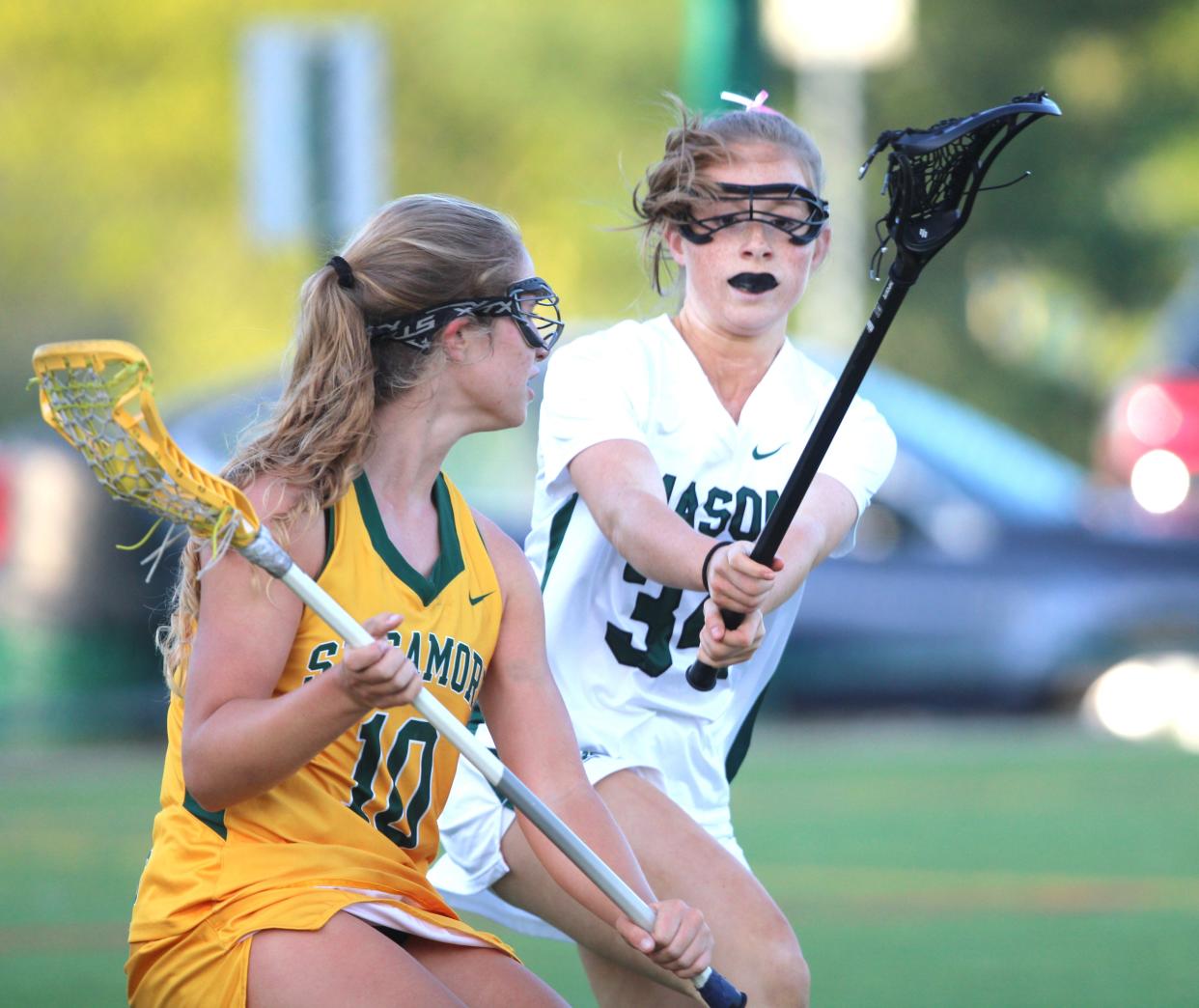 Mason senior Anna Schmeichel (34) pressures Sycamore junior Tess Geiger (10) as Sycamore defeated Mason 16-3 Thursday.