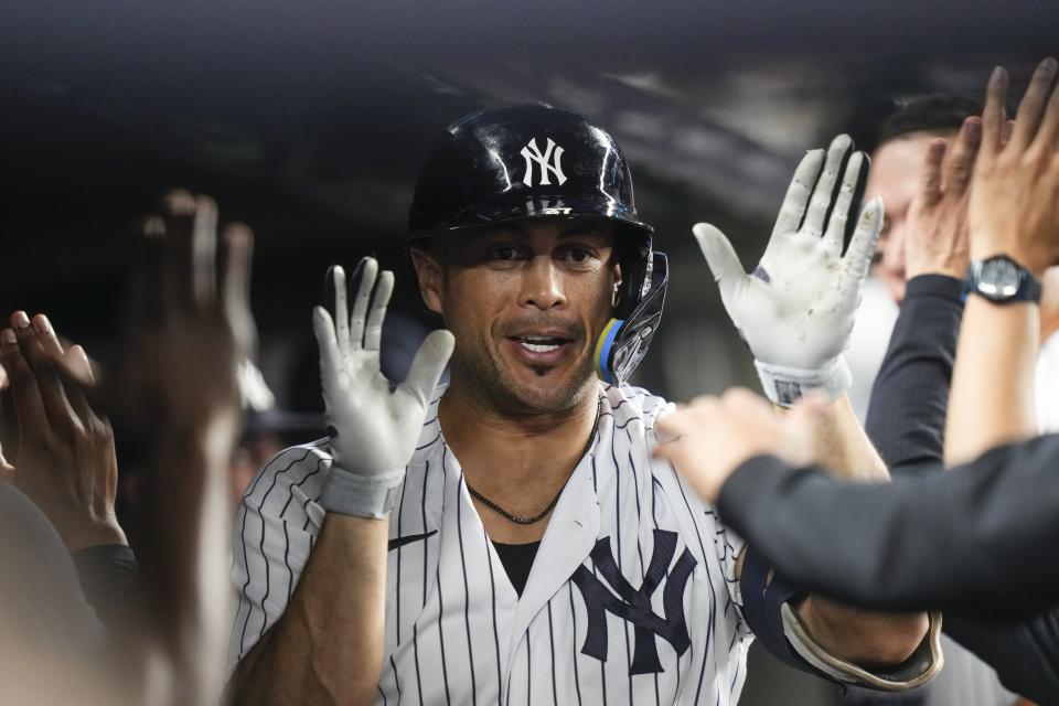 New York Yankees' Giancarlo Stanton celebrates with teammates after hitting a home run against the Minnesota Twins during the sixth inning of a baseball game Friday, April 14, 2023, in New York. (AP Photo/Frank Franklin II)