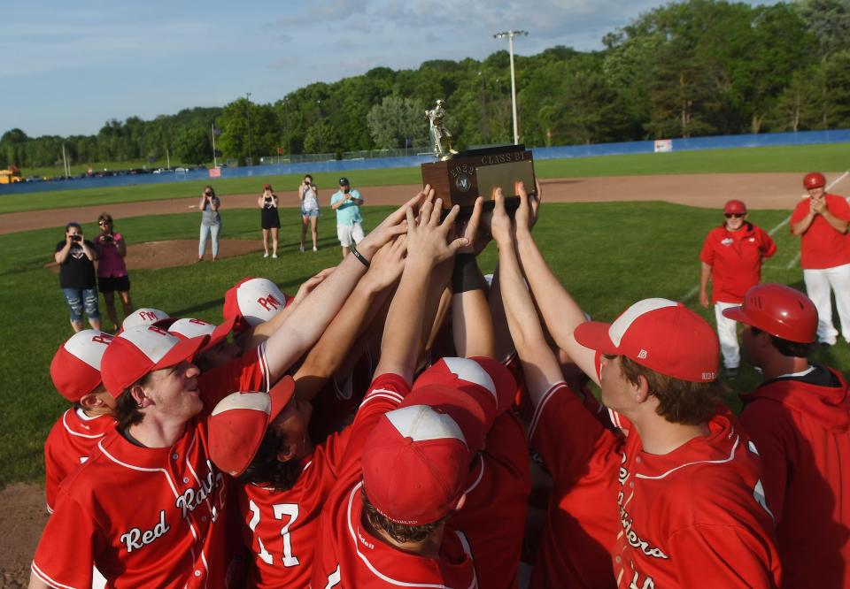 Members of the Palmyra-Macedon Red Raiders hoist up the Section V Class B1 trophy.