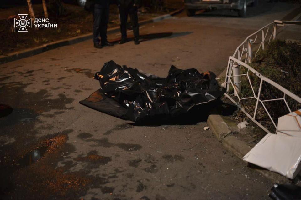 In this photo provided by the Ukrainian Emergency Service, bodies killed in an apartment building are seen covered in a yard after a Russian attack in Kryvyi Rih, Ukraine, Wednesday, March 13, 2024. At least a few people were killed and dozens more were wounded on Tuesday evening as the result of a Russian missile strike on Zelenskyy's hometown. (Ukrainian Emergency Service via AP)