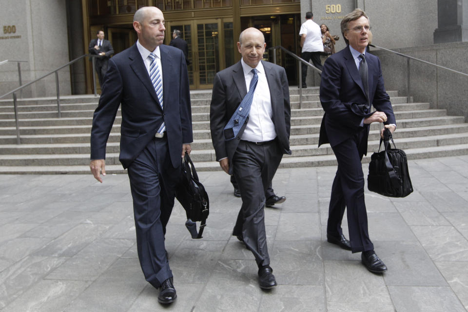 Goldman Sachs chairman and chief executive officer Lloyd Blankfein, center, leaves Federal court, Thursday, June 7, 2012 in New York. Blankfein testified at the New York insider trading trial of a former Goldman board member Rajat Gupta. (AP Photo/Mary Altaffer)