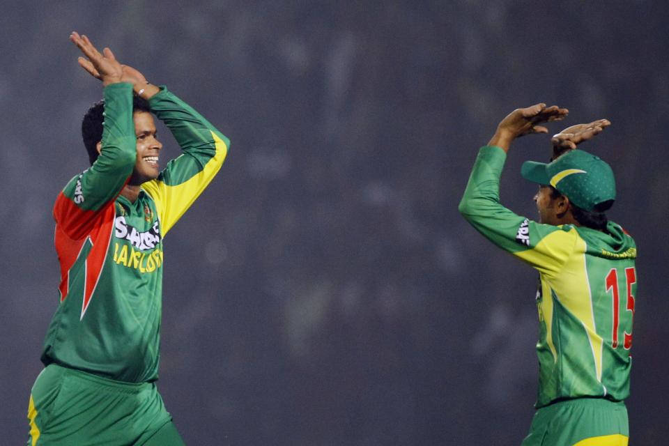 Bangladesh’s Abdur Razzak, left, and captain Mushfiqur Rahim celebrate the dismissal of India’s Shikhar Dhawan during the Asia Cup one-day international cricket tournament between them in Fatullah, near Dhaka, Bangladesh, Wednesday, Feb. 26, 2014. (AP Photo/A.M. Ahad)