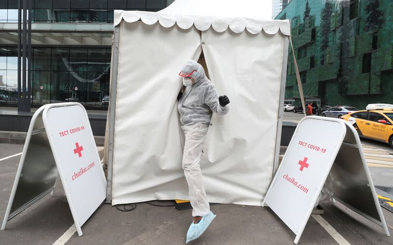 A medical specialist walks out of a mobile laboratory carrying out tests to detect the coronavirus disease in Moscow