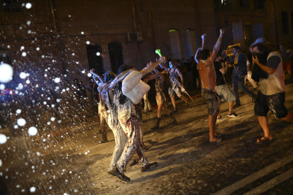 Israeli police uses water canon to disperse people during a protest against Israeli Prime Minister Benjamin Netanyahu In Jerusalem Saturday, July 18, 2020. Protesters demanded that the embattled Israeli leader to resign as he faces a trial on corruption charges and grapples with a deepening coronavirus crisis.(AP Photo/Oded Balilty)