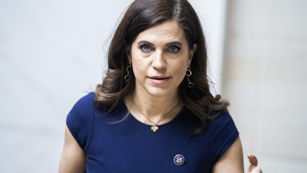 Rep. Nancy Mace, wearing a dark-blue dress with short sleeves and gold earrings and necklace.