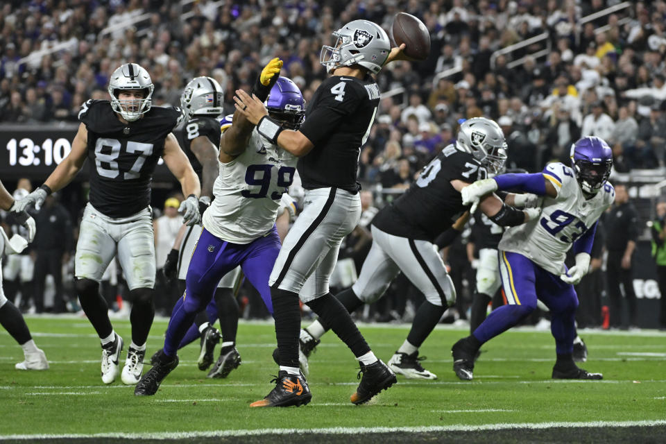 Las Vegas Raiders quarterback Aidan O'Connell (4) is pressured by Minnesota Vikings linebacker Danielle Hunter (99) during the second half of an NFL football game, Sunday, Dec. 10, 2023, in Las Vegas. (AP Photo/David Becker)