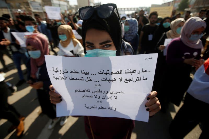 An Iraqi student takes part at an ongoing anti-government protests, in Basra