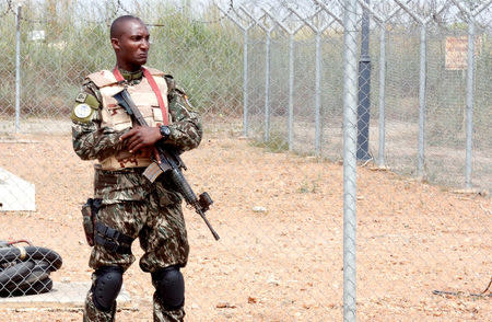 Security forces member stands guard at the airport as Ivory Coast's Minister of Defense Alain-Richard Donwahi arrives to speak with mutinous soldiers in Bouake, Ivory Coast January 13, 2017. REUTERS/Thierry Gouegnon