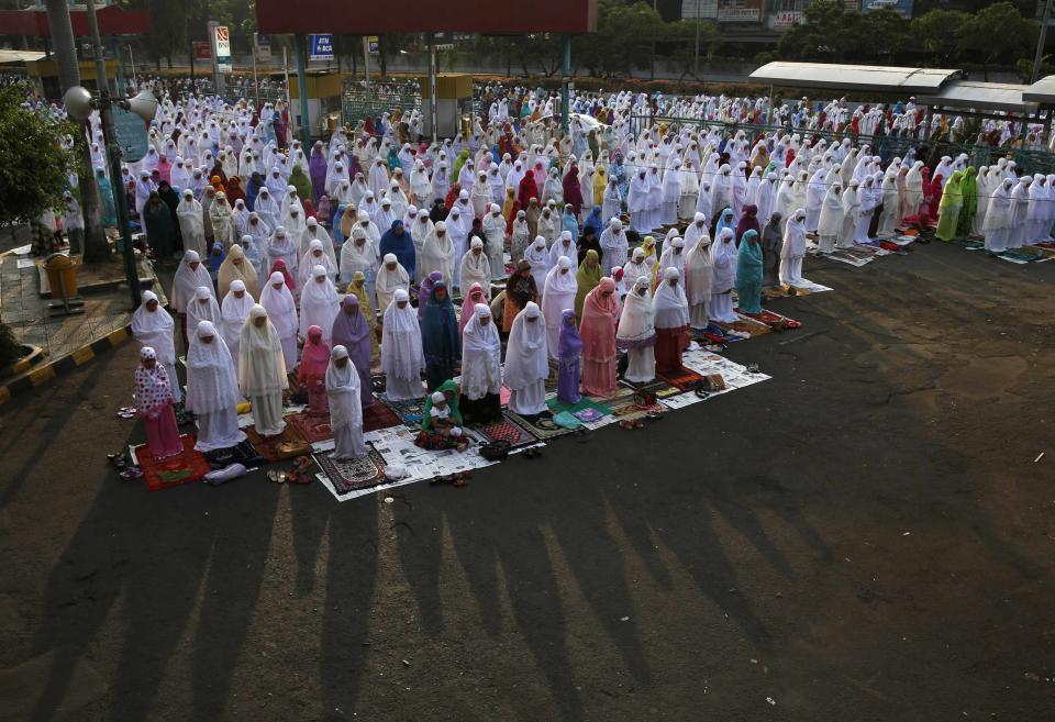 Muslim women attend an Eid al-Adha mass prayer at Senen market in Jakarta