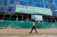 A man walks past a suspended construction project in Yangon, Myanmar, July 21, 2016. Picture taken July 21, 2016. REUTERS/Soe Zeya Tun