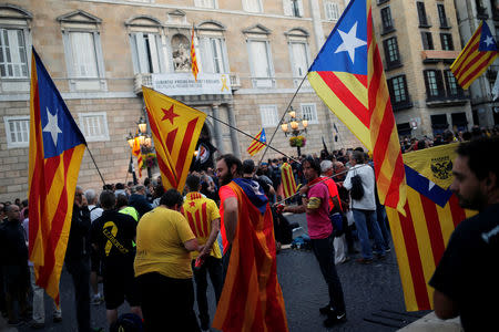 People wave "Esteladas" (Catalan separatist flags) as they stage a sit-in during an occupation of the Sant Jaume square, as a part of events planned to mark the first anniversary of the banned independence referendum held in the region on October 1, 2017, in front of the Catalan regional government headquarters in Barcelona, Spain, September 29, 2018. REUTERS/Jon Nazca