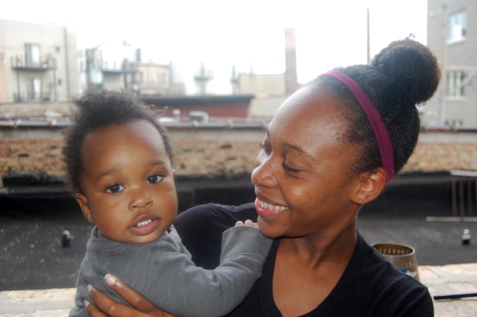 This 2013 image released by blogger Leila Noelliste, 28, shows her with her 12-month-old son Noah in Chicago. Noelliste has been blogging about natural hair at Blackgirllonghair.com for about five years. (AP Photo/Leila Noelliste)