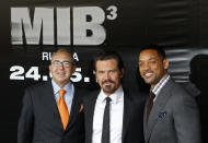 Director Barry Sonnenfeld, left, and actors Will Smith, right, and Josh Brolin pose for photographers at a cinema during a photocall for their film "Men in Black 3" in Moscow, Russia, Friday, April 18, 2012. The film premiere in Russia is scheduled for May 24. (AP Photo/Misha Japaridze)