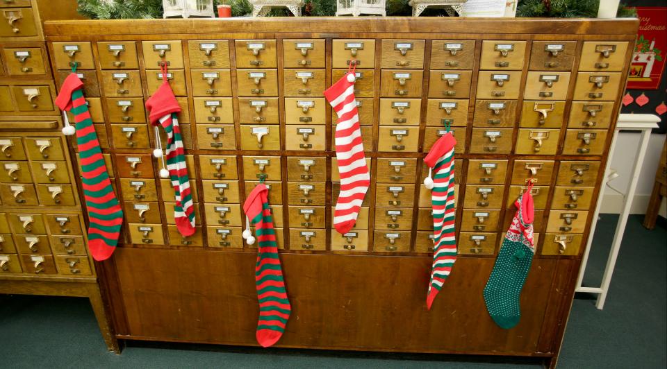 Stockings were hung on the card catolog with care for the Sheboygan County Historical Research Center’s Treemendous Celebration holiday display as seen, Wednesday, November 30, 2022, in Sheboygan Falls, Wis.