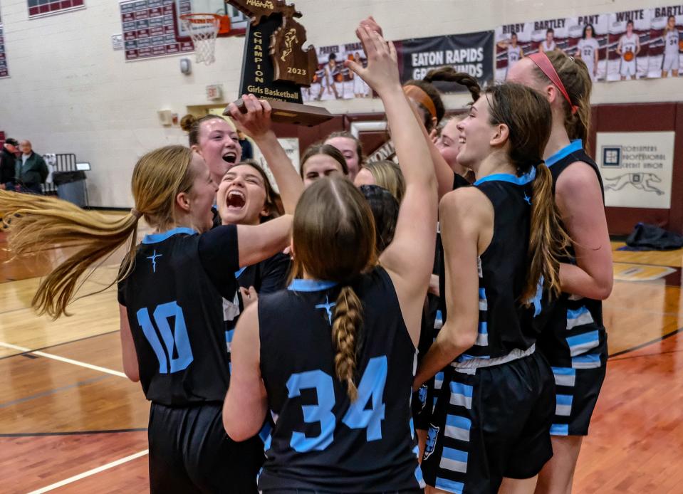 Lansing Catholic celebrates their district championship win over Haslett Saturday, Mar. 4, 2023.