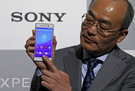 Sony Mobile Communications Inc President and CEO Hiroki Totoki poses with Sony's new Xperia Z4 smartphone after a news conference in Tokyo April 20, 2015. REUTERS/Toru Hanai