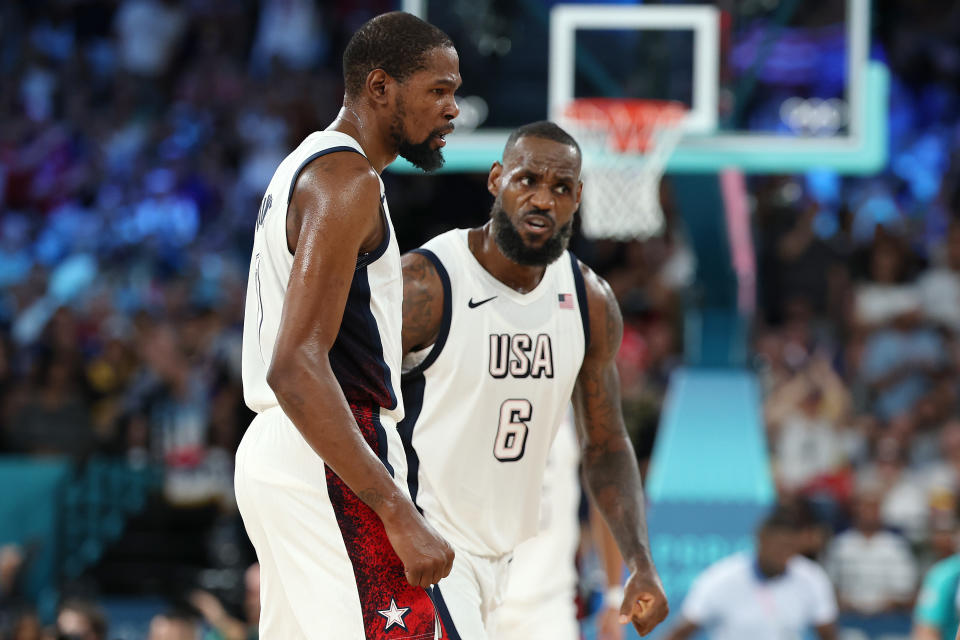 PARIS, FRANCE - AUGUST 08: Kevin Durant #7 and Lebron James #6 of Team United States react after winning a Men's basketball semifinals match between Team United States and Team Serbia on day thirteen of the Olympic Games Paris 2024 at Bercy Arena on August 08, 2024 in Paris, France. (Photo by Gregory Shamus/Getty Images)