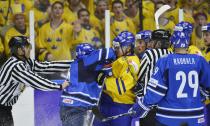 Finland's Rasmus Ristolainen (2nd L) hits Sweden's Robert Hagg during their IIHF World Junior Championship Group B preliminary round ice hockey match at Malmo Arena in Malmo, December 28, 2013. REUTERS/Ludvig Thunman/TT News Agency (SWEDEN - Tags: SPORT ICE HOCKEY) ATTENTION EDITORS - THIS IMAGE HAS BEEN SUPPLIED BY A THIRD PARTY. IT IS DISTRIBUTED, EXACTLY AS RECEIVED BY REUTERS, AS A SERVICE TO CLIENTS. SWEDEN OUT. NO COMMERCIAL OR EDITORIAL SALES IN SWEDEN. NO COMMERCIAL SALES