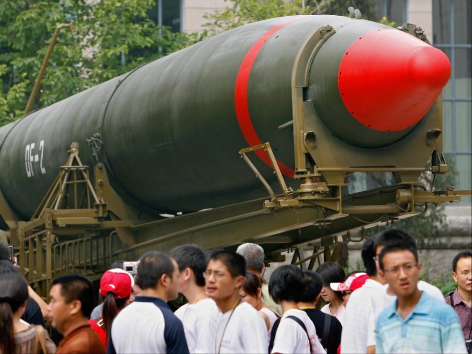 Visitors in Beijing walk past China’s second ever nuclear missile on display at a museum (AFP via Getty Images)