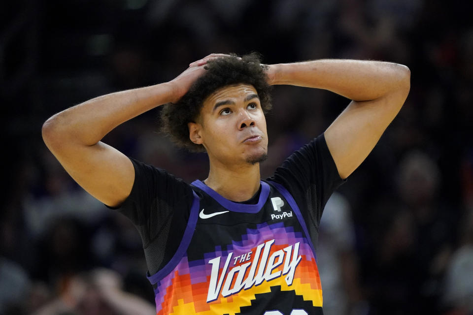 Phoenix Suns forward Cameron Johnson looks at the scoreboard during the first half of Game 7 of an NBA basketball Western Conference playoff semifinal against the Dallas Mavericks, Sunday, May 15, 2022, in Phoenix. (AP Photo/Matt York)