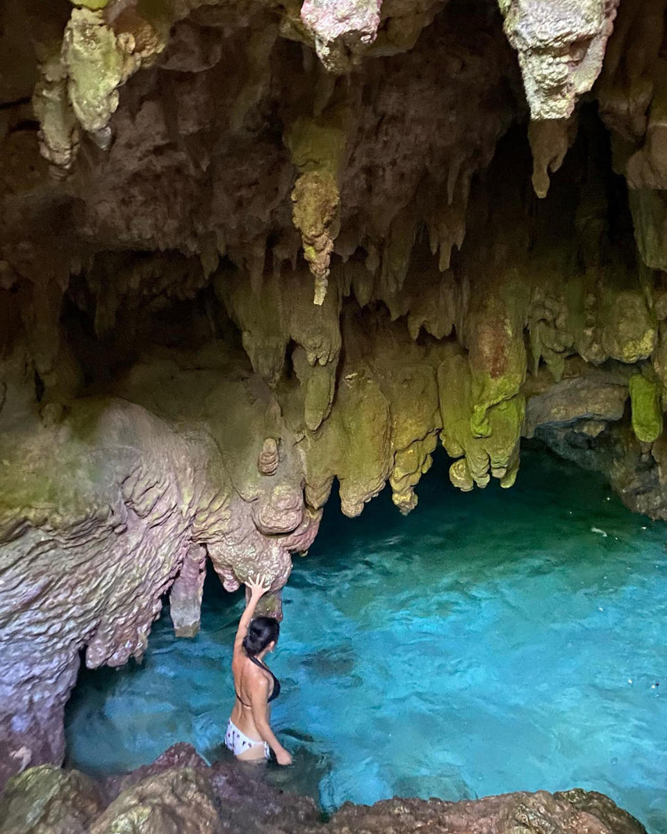 Poh Ling Yeow walking into an underground pool, called The Grotto in Christmas Island