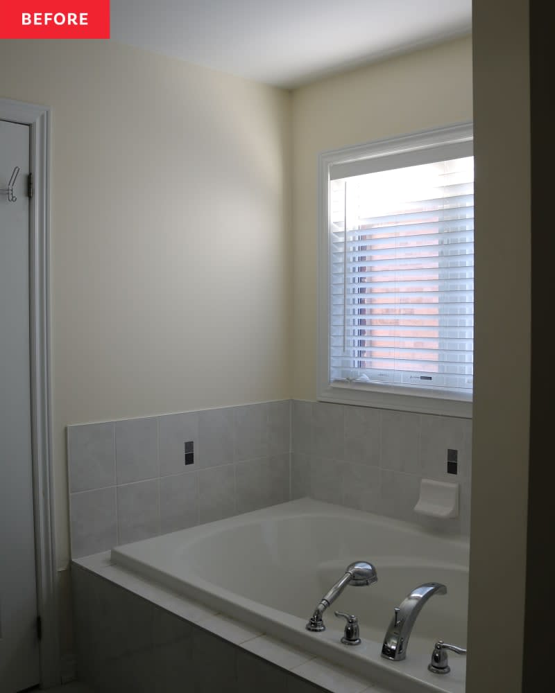 Bathtub in light colored bathroom before renovations.