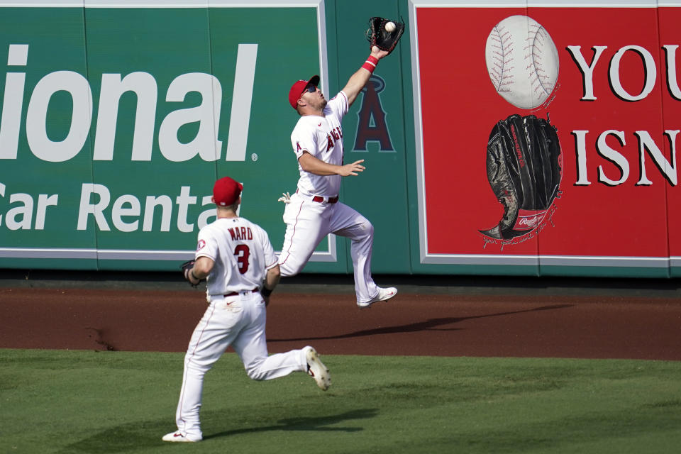 Los Angeles Angels center fielder Mike Trout, top, makes a leaping catch on a line drive from Arizona Diamondbacks' Carson Kelly during the seventh inning of a baseball game Thursday, Sept. 17, 2020, in Anaheim, Calif. (AP Photo/Marcio Jose Sanchez)