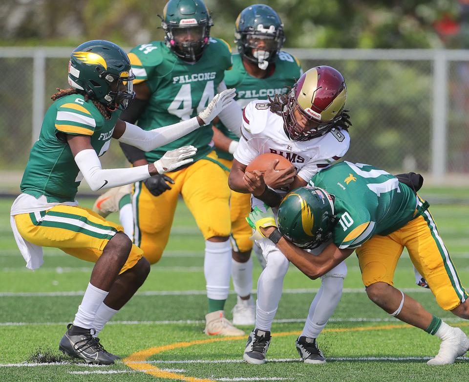 Garfield quarterback Kevin Strickling is swarmed by Firestone defenders Matthew White (2), William Calhoun (44), Dionte Younger (22) and Isaiah Ramer (10) on Sept. 23 in Akron.