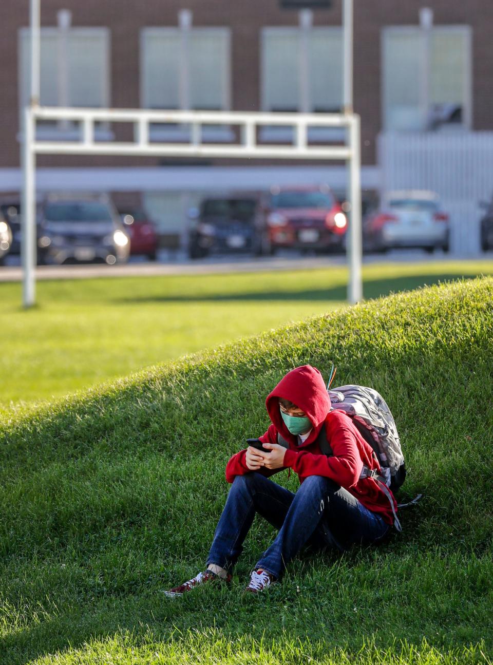 FILE - A Washington Middle School student looks over his phone before classes Aug. 30, 2021, on the school's campus.