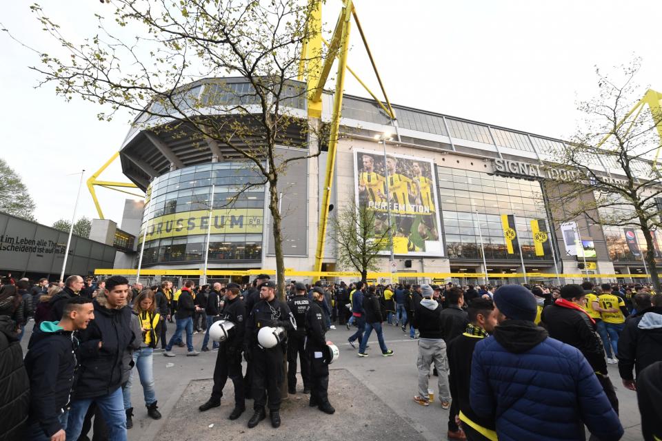 <p>Police officers and fans stand in front of the Signal Iduna Park in Dortmund, Germany, Tuesday, April 11. The first leg of the Champions League quarter final soccer match between Borussia Dortmund and AS Monaco had been cancelled to an explosion. (AP Photo/Bernd Thissen/dpa via AP </p>