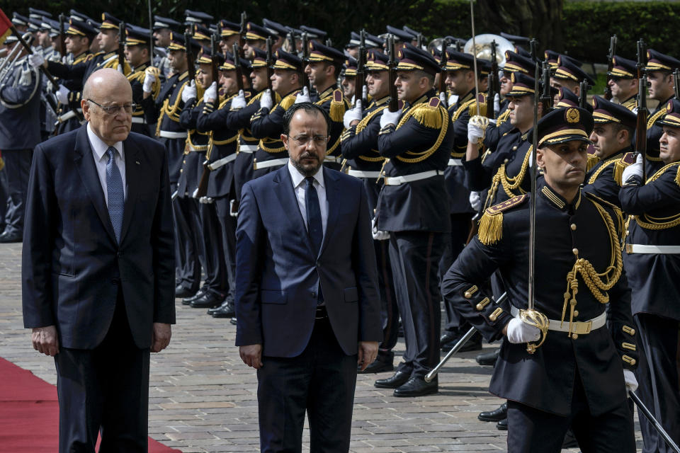 Cyprus' President Nikos Christodoulides, on carpet right, attends a military welcome ceremony with Lebanese caretaker Prime Minister Najib Mikati,on carpet left, upon his arrival to the government headquarters in Beirut, Lebanon, Monday, April 8, 2024. Christodoulides' visit to Beirut comes after he asked the European Union last week to intervene with Lebanese authorities to stop boatloads of Syrian refugees from heading to the east Mediterranean island nation. Lebanon's caretaker prime minister asked Southern European countries along the Mediterranean Sea to pressure the European Union to help Lebanon deport undocumented migrants. (AP Photo/Bilal Hussein)