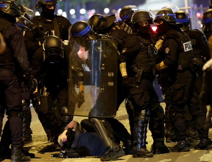 French police officers detain a demonstrator in Paris (AFP via Getty Images)