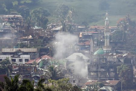 Smoke is seen while Philippines army troops continue their assault against insurgents from the Maute group in Marawi City, Philippines June 28, 2017. REUTERS/Jorge Silva