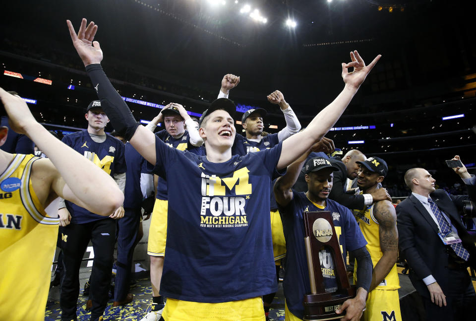 Michigan forward Moritz Wagner, foreground, and teammates celebrate after defeating Florida State 58-54 in an NCAA men’s college basketball tournament regional final Saturday, March 24, 2018, in Los Angeles. (AP Photo/Alex Gallardo)