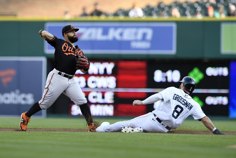 Baltimore Orioles second baseman Rougned Odor throws to first base to complete a double play as Detroit Tigers' Robbie Grossman slides into second base during the first inning of a baseball game Friday, May 13, 2022, in Detroit. Javier Baez was out at first. (AP Photo/Jose Juarez)