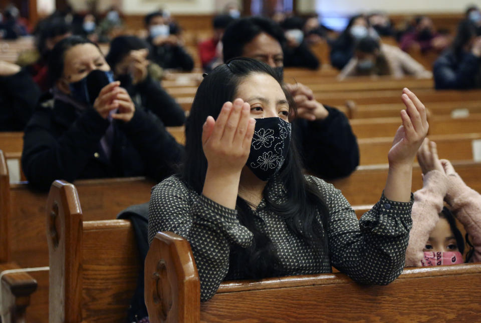 Parishioners pray during Mass at Our Lady of Sorrows in the Queens borough of New York on Sunday, March 7, 2021. The Roman Catholic church reopened for in-person services in July 2020 and recently resumed in-person confessions. (AP Photo/Jessie Wardarski)