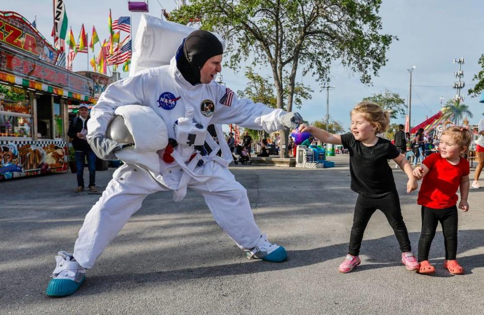 Kloe Ball-Liivera, 3, high fives Billy Jones playing as Jet the Astornaut during the 2024 Miami-Dade County Youth Fair & Exposition. The theme of the 72nd edition is “Spaceventure,” held in Miami on Thursday, March 14, 2024.