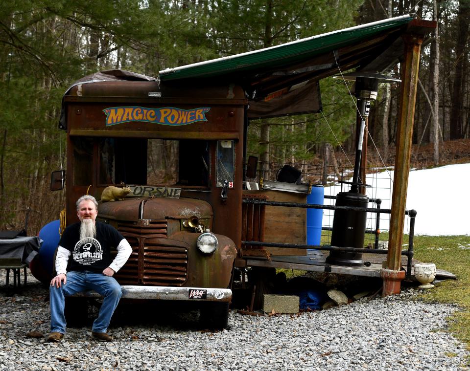 Blue Collar Vintage owner Anthony Brooks with his outdoor stage complete with a bumper from a 1946 GMC truck from the old Railway Express Agency.