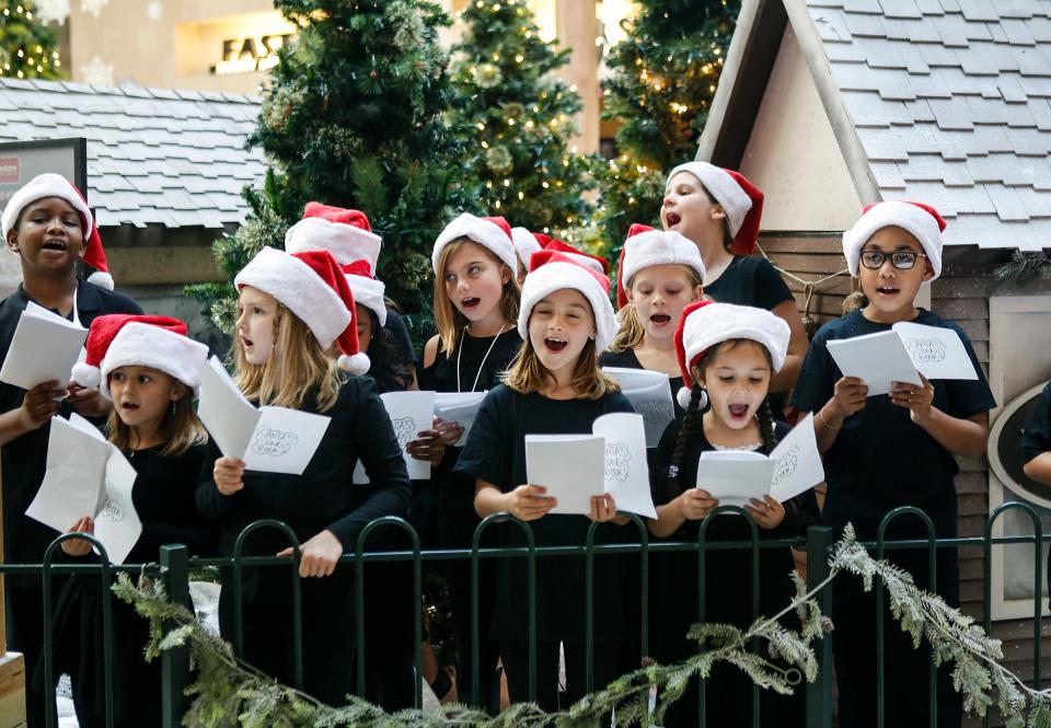 Children from Christ Fellowship Church sing Christmas Carols at the Santa Arrival Party at Boynton Beach Mall in November 2016.