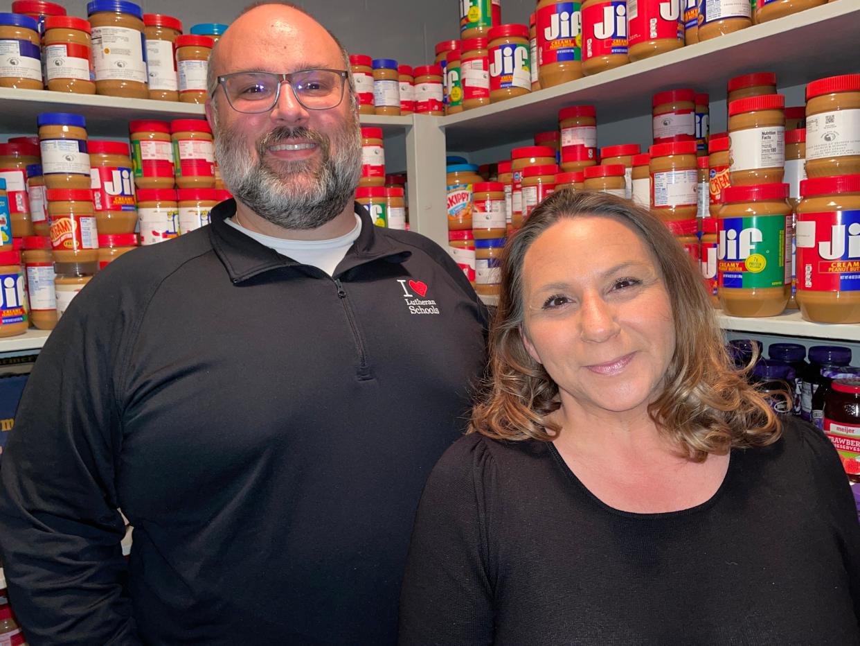 Pastor Daniel Potts and Alison Beeker stand in the food pantry at Trinity Lutheran Church in Monroe.
