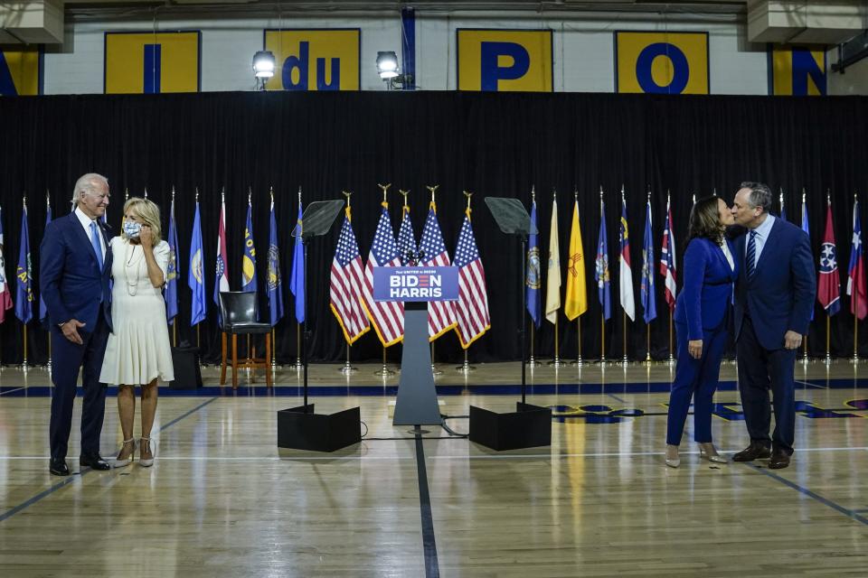 Presumptive Democratic presidential nominee Joe Biden, with wife Dr. Jill Biden, and his running mate Sen. Kamala Harris (D-CA), with husband Douglas Emhoff, stand socially distanced apart after delivering remarks at the Alexis Dupont High School on August 12, 2020 in Wilmington, Delaware.