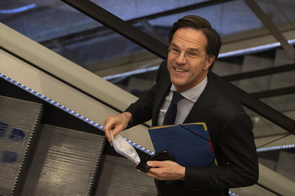 Caretaker Dutch Prime Minister Mark Rutte leaves after surviving a no-confidence motion in parliament in The Hague, Netherlands, early Friday, April 2, 2021. Rutte was fighting for his political life in a bitter parliamentary debate about the country's derailed process of forming a new ruling coalition following elections last month. (AP Photo/Peter Dejong)
