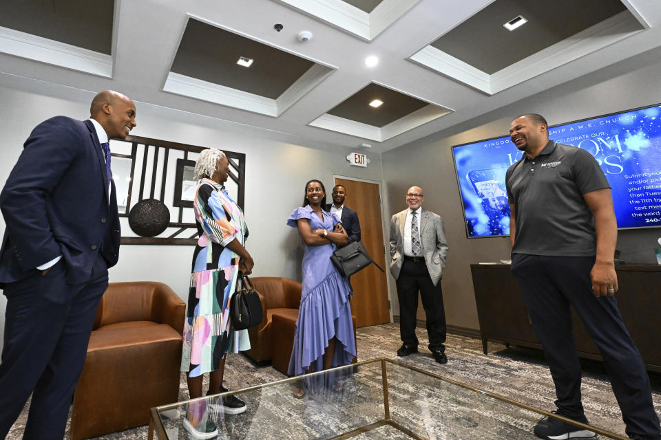 Reverend Matthew L. Watley, right, talks with members of Kingdom Fellowship AME Church in his office before service, Sunday, June 2, 2024, in Calverton, Md. The suburban Maryland congregation, led by Rev. Watley, has landed at the top of a list of the fastest-growing churches in America. (AP Photo/Terrance Williams)