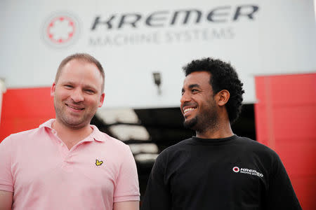 Tilman Mues, managing partner of German plant engineering firm Kremer Machine Systems and his employee and immigrant from Eritrea Merhawi Tesfay during a Reuters interview in Gescher near Muenster, Germany, August 4, 2017. REUTERS/Wolfgang Rattay