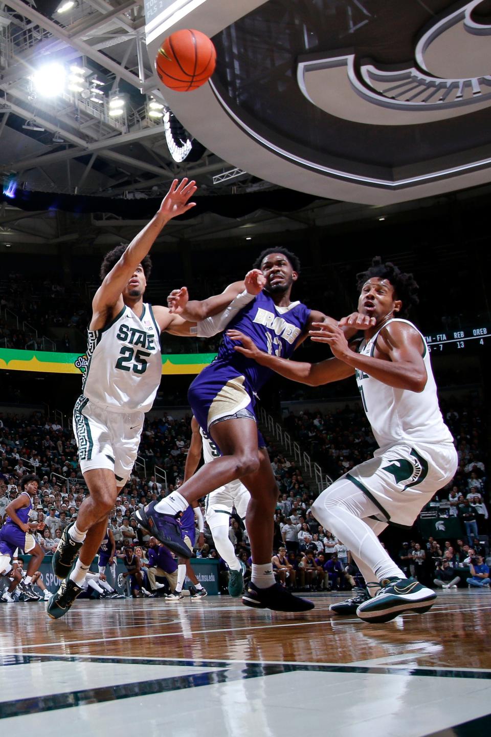 Michigan State's Malik Hall, left, and A.J. Hoggard, right, and Alcorn State's Jeremiah Kendall chase a rebound during MSU's 81-39 win on Sunday, Nov. 19, 2023, at Breslin Center.